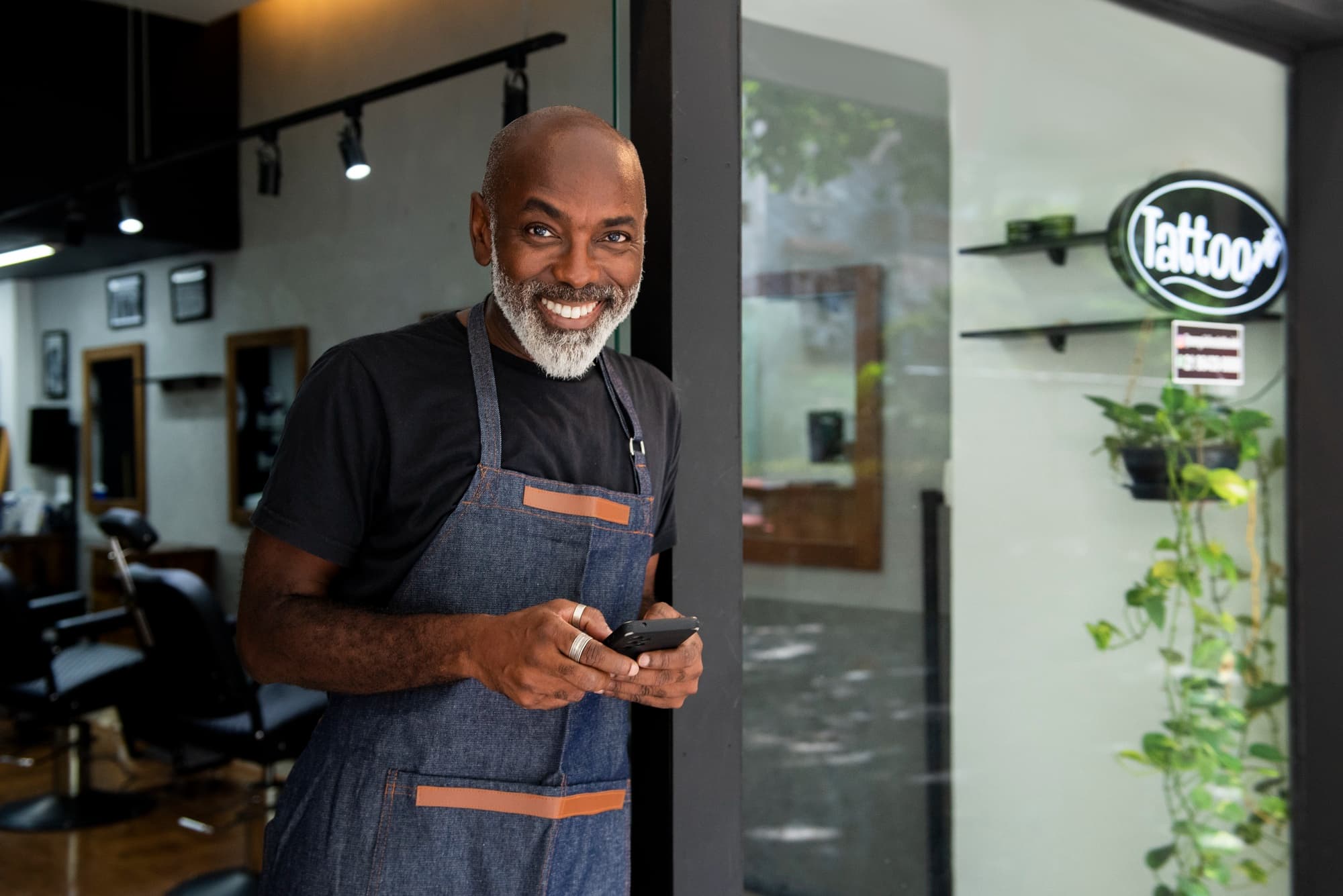 Business owner at the door of their salon